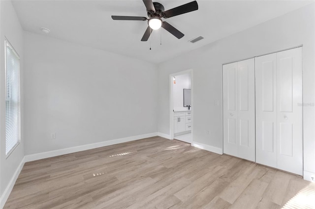 8112 N 10th St, Tampa, FL 33604 - unfurnished bedroom featuring light wood finished floors, multiple windows, and baseboards