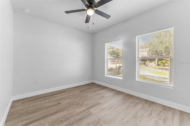 8112 N 10th St, Tampa, FL 33604 - empty room with light wood finished floors, baseboards, a smoke detector, and ceiling fan