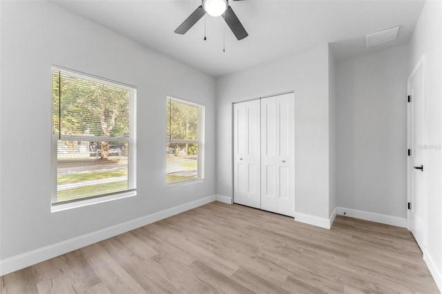 8112 N 10th St, Tampa, FL 33604 - unfurnished bedroom with light wood-style flooring, baseboards, a closet, and a ceiling fan