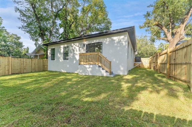 8112 N 10th St, Tampa, FL 33604 - back of house featuring stucco siding and a gate