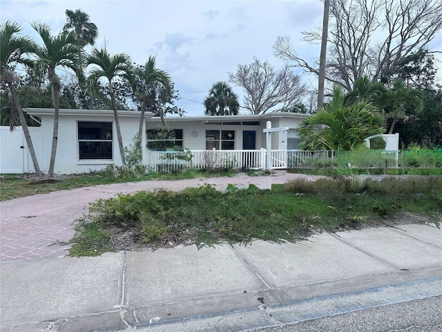 709 Pruitt Dr, Madeira Beach, FL 33708 - single story home with a porch and stucco siding