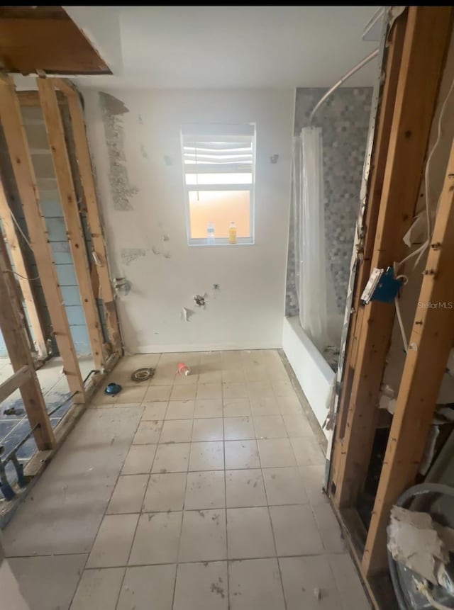 709 Pruitt Dr, Madeira Beach, FL 33708 - bathroom with shower / bath combination with curtain and tile patterned floors