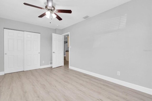 5685 35th Ave N, Saint Petersburg, FL 33710 - unfurnished bedroom featuring wood finished floors, baseboards, a closet, and ceiling fan