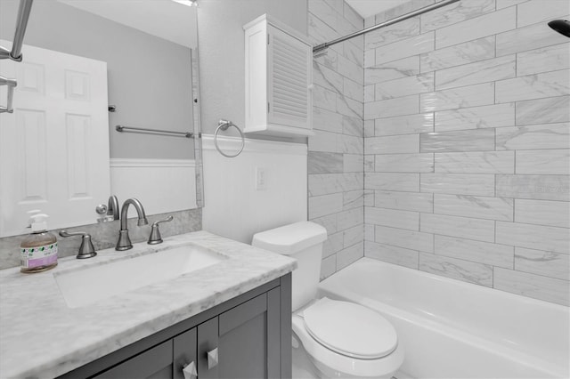 5685 35th Ave N, Saint Petersburg, FL 33710 - bathroom featuring vanity, toilet, shower / bathtub combination, and a wainscoted wall