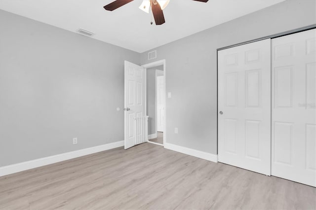 5685 35th Ave N, Saint Petersburg, FL 33710 - unfurnished bedroom with wood finished floors, baseboards, a closet, and ceiling fan
