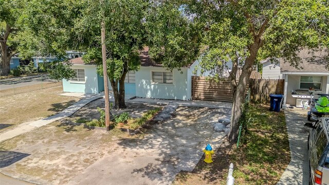 8525 N Ola Ave, Tampa, FL 33604 - view of property hidden behind natural elements with stucco siding