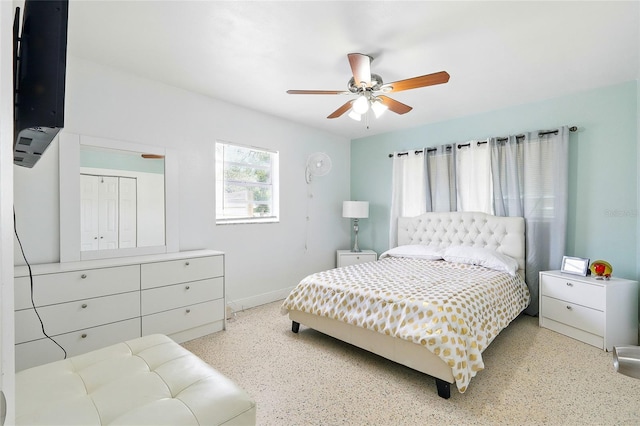 8525 N Ola Ave, Tampa, FL 33604 - bedroom featuring dark speckled floor, baseboards, and a ceiling fan