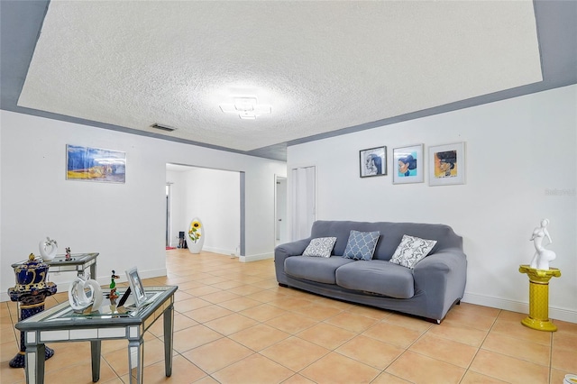8525 N Ola Ave, Tampa, FL 33604 - living room featuring light tile patterned flooring, a textured ceiling, and baseboards