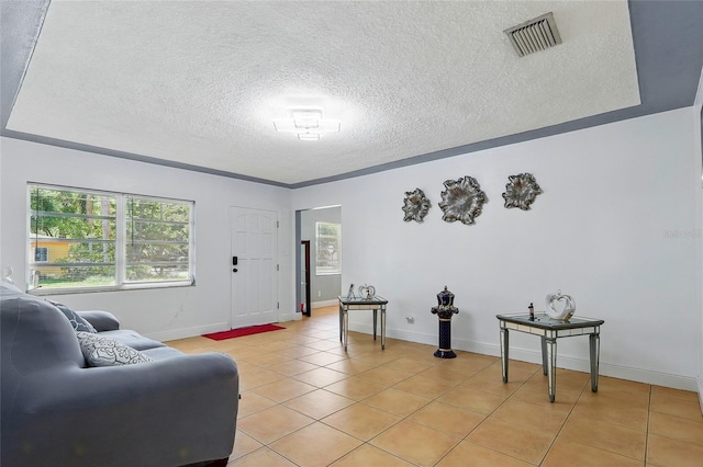 8525 N Ola Ave, Tampa, FL 33604 - living area featuring a textured ceiling, light tile patterned floors, and baseboards