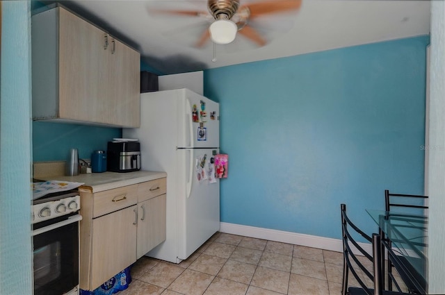 8525 N Ola Ave, Tampa, FL 33604 - kitchen with electric range, freestanding refrigerator, a ceiling fan, light countertops, and light tile patterned flooring
