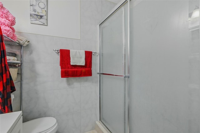 8525 N Ola Ave, Tampa, FL 33604 - bathroom with a stall shower, toilet, vanity, and tile walls