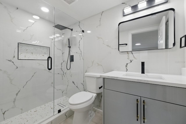 15025 Shark St, Hudson, FL 34667 - bathroom featuring tile walls, vanity, toilet, and a marble finish shower
