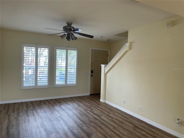 13290 Thoroughbred Loop, Largo, FL 33773 - unfurnished living room with ceiling fan, dark wood-style flooring, and stairway