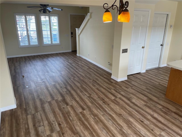 13290 Thoroughbred Loop, Largo, FL 33773 - unfurnished living room featuring ceiling fan, dark wood-style floors, a chandelier, and stairway