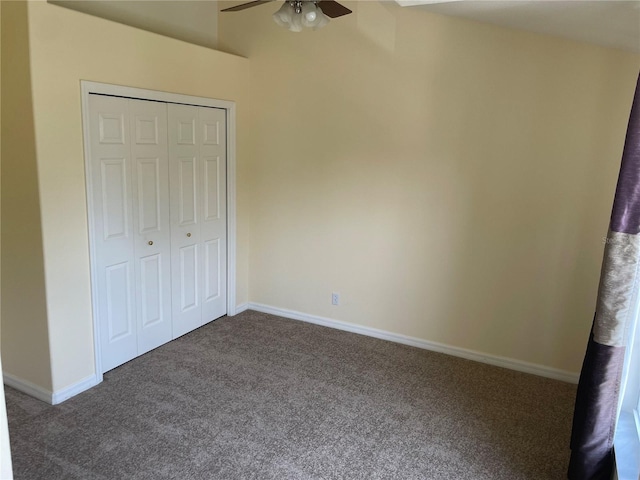 13290 Thoroughbred Loop, Largo, FL 33773 - unfurnished bedroom with dark carpet, a closet, and ceiling fan