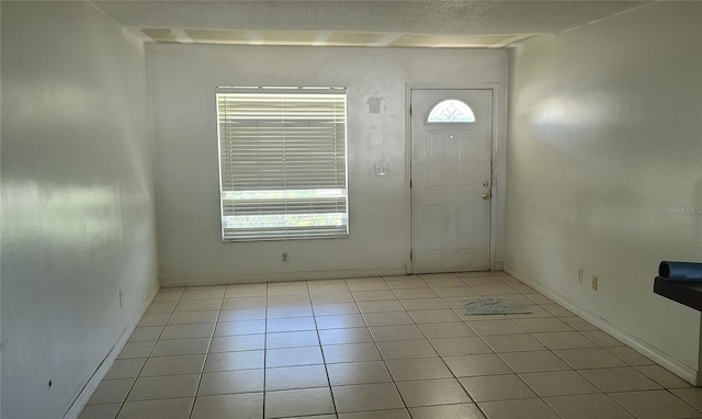 2603 Mary Sue St SW, Largo, FL 33774 - foyer entrance featuring light tile patterned flooring and baseboards