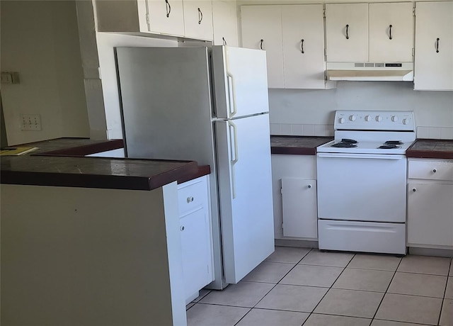 2603 Mary Sue St SW, Largo, FL 33774 - kitchen with white appliances, under cabinet range hood, dark countertops, white cabinetry, and light tile patterned floors