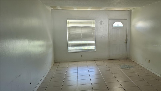 2603 Mary Sue St SW, Largo, FL 33774 - foyer featuring light tile patterned floors and baseboards
