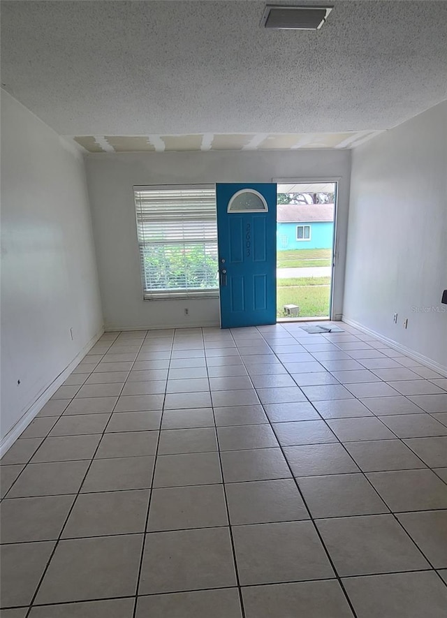 2603 Mary Sue St SW, Largo, FL 33774 - tiled empty room featuring a textured ceiling