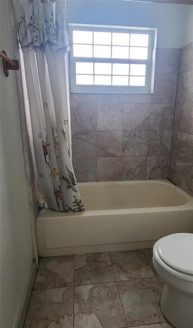 2603 Mary Sue St SW, Largo, FL 33774 - bathroom with marble look tile flooring, toilet, and shower / tub combo with curtain