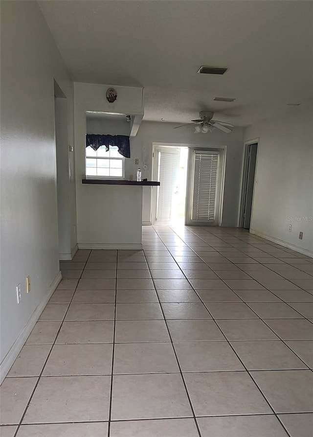 2603 Mary Sue St SW, Largo, FL 33774 - empty room featuring light tile patterned floors, ceiling fan, and baseboards