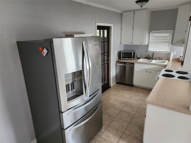 11107 Riverview Dr, Riverview, FL 33578 - kitchen featuring stainless steel appliances, white cabinetry, light countertops, and light tile patterned floors