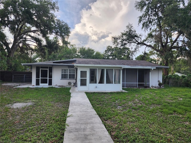 11107 Riverview Dr, Riverview, FL 33578 - rear view of house with a sunroom