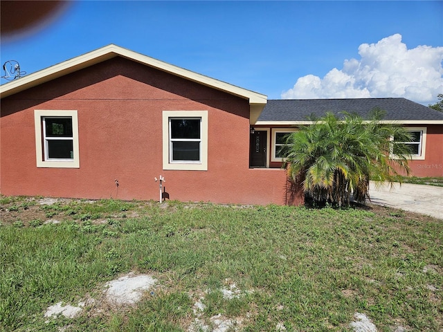 11210 Mcmullen Rd, Riverview, FL 33569 - view of home's exterior with a lawn, stucco siding, and concrete driveway