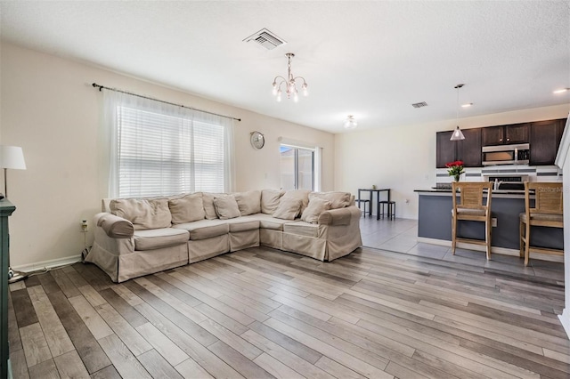 30989 Summer Sun Loop, Wesley Chapel, FL 33545 - living area featuring a chandelier, light wood-type flooring, baseboards, and recessed lighting