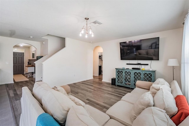 30989 Summer Sun Loop, Wesley Chapel, FL 33545 - living area featuring arched walkways, wood finished floors, baseboards, stairs, and a chandelier