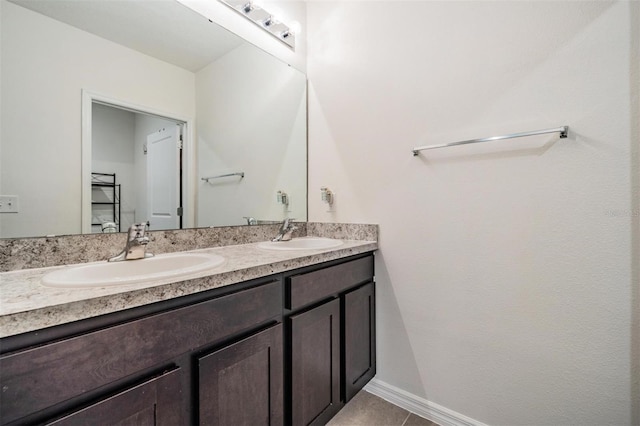 30989 Summer Sun Loop, Wesley Chapel, FL 33545 - full bathroom with double vanity, tile patterned floors, and baseboards