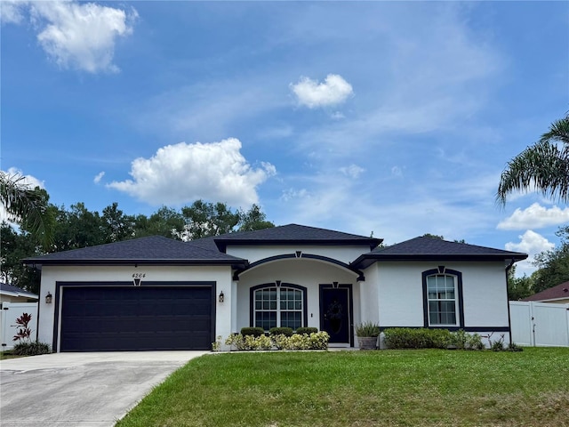 4264 Michaler St, North Port, FL 34286 - ranch-style house featuring a garage, concrete driveway, stucco siding, and a gate