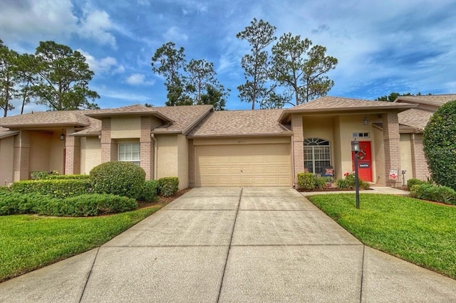 18531 Bent Pine Dr, Hudson, FL 34667 - view of front of home featuring stucco siding, a garage, concrete driveway, a front lawn, and brick siding