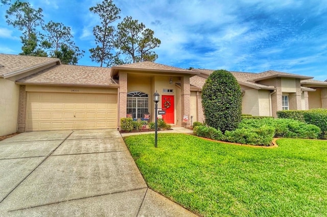 18531 Bent Pine Dr, Hudson, FL 34667 - view of front of home featuring a garage, a front yard, and stucco siding
