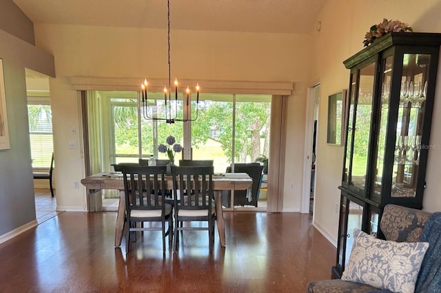 18531 Bent Pine Dr, Hudson, FL 34667 - dining area with a chandelier, wood finished floors, and baseboards