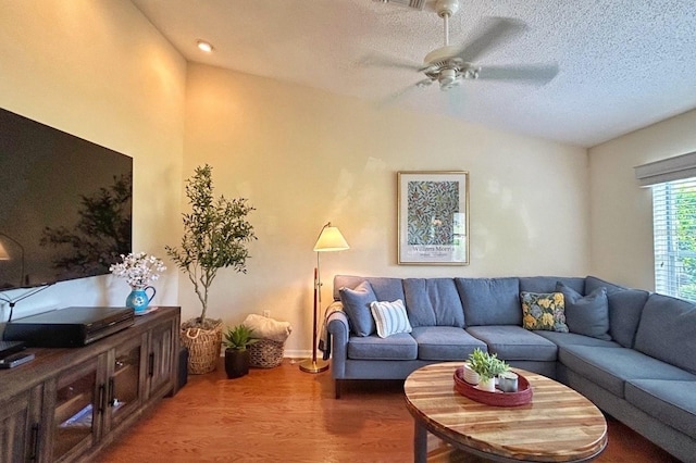 18531 Bent Pine Dr, Hudson, FL 34667 - living area with vaulted ceiling, ceiling fan, wood finished floors, and a textured ceiling