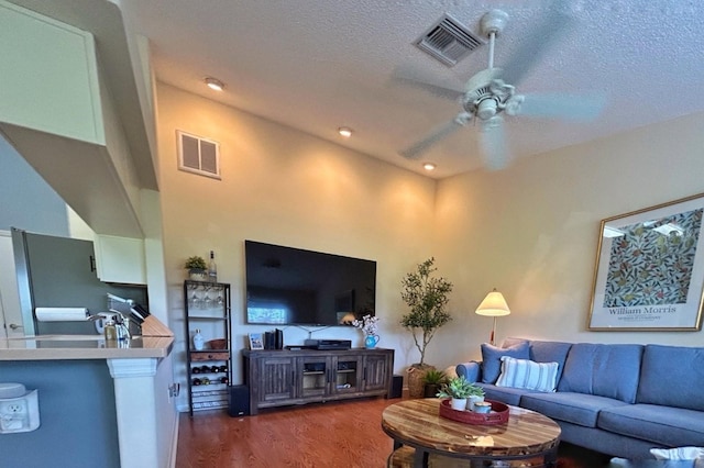 18531 Bent Pine Dr, Hudson, FL 34667 - living room with ceiling fan, wood finished floors, and a textured ceiling