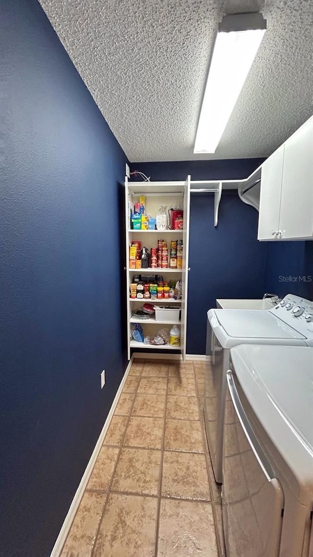 18531 Bent Pine Dr, Hudson, FL 34667 - washroom with cabinet space, a textured ceiling, washer and clothes dryer, and baseboards