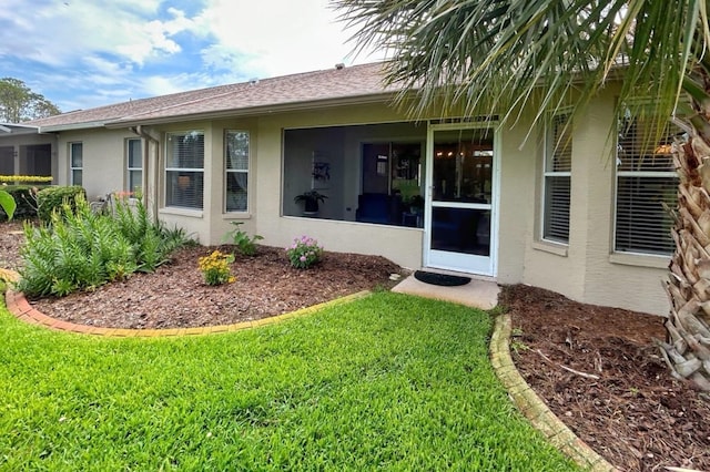 18531 Bent Pine Dr, Hudson, FL 34667 - property entrance featuring stucco siding, a yard, and a shingled roof