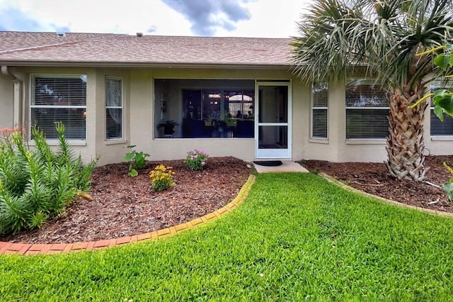 18531 Bent Pine Dr, Hudson, FL 34667 - property entrance with stucco siding and a lawn