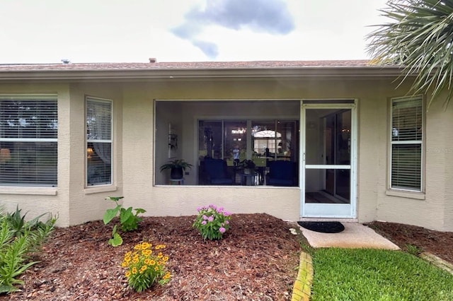 18531 Bent Pine Dr, Hudson, FL 34667 - view of exterior entry featuring stucco siding