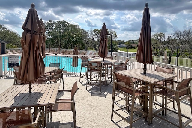 18531 Bent Pine Dr, Hudson, FL 34667 - view of patio featuring outdoor dining space and a community pool