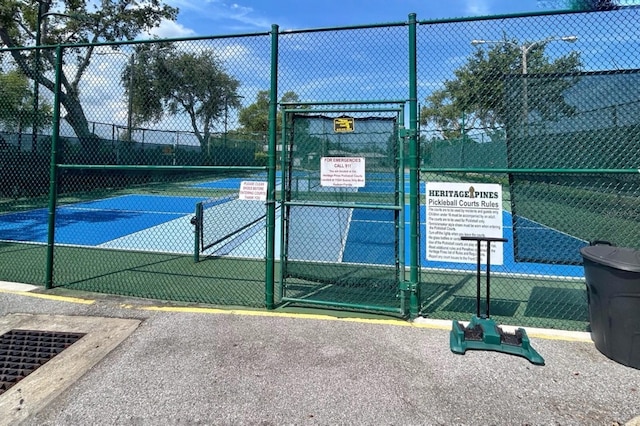 18531 Bent Pine Dr, Hudson, FL 34667 - view of tennis court featuring a gate