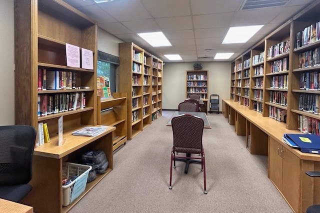 18531 Bent Pine Dr, Hudson, FL 34667 - office area with wall of books, a drop ceiling, and carpet floors