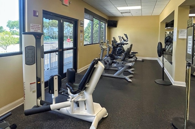 18531 Bent Pine Dr, Hudson, FL 34667 - gym with a drop ceiling, baseboards, and healthy amount of natural light