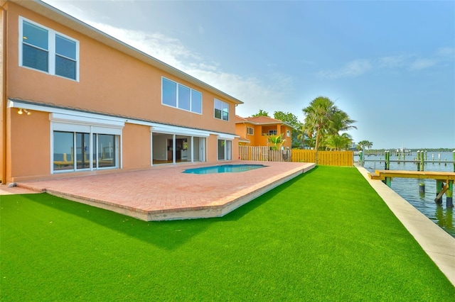 4823 Arlington Rd, Palmetto, FL 34221 - back of property with stucco siding, a patio area, and a water view