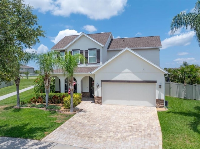11904 Greenchop Pl, Riverview, FL 33579 - view of front facade with decorative driveway, stucco siding, a garage, and a shingled roof