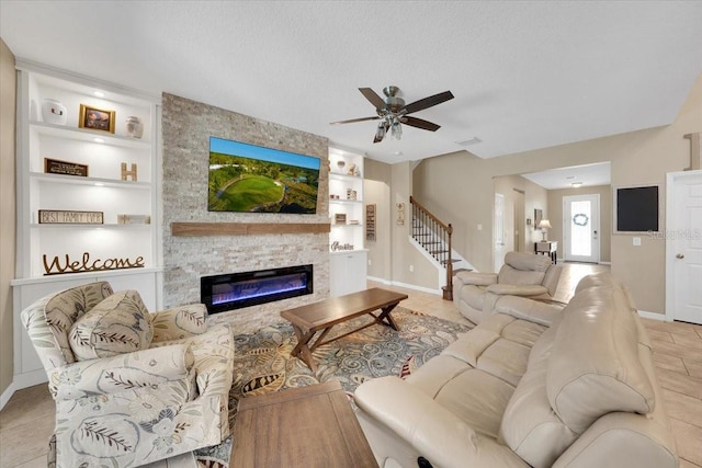 11904 Greenchop Pl, Riverview, FL 33579 - living area featuring built in shelves, baseboards, tile patterned flooring, a large fireplace, and stairs