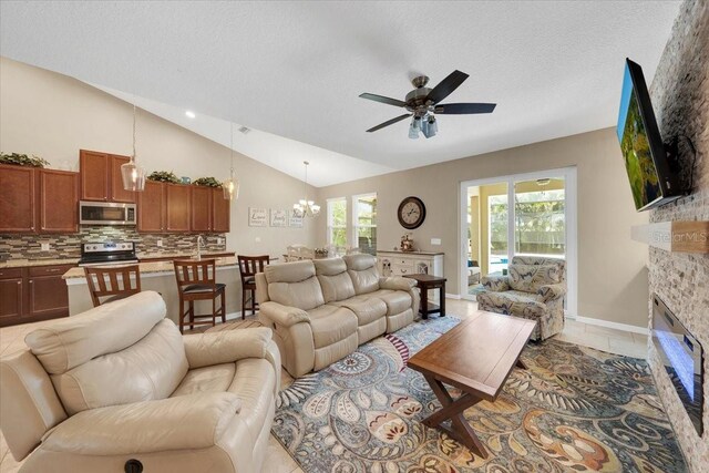 11904 Greenchop Pl, Riverview, FL 33579 - living area with lofted ceiling, ceiling fan, a fireplace, a textured ceiling, and a chandelier