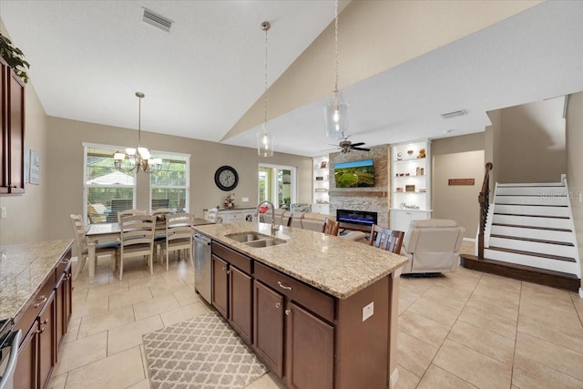 11904 Greenchop Pl, Riverview, FL 33579 - kitchen with a sink, a large fireplace, stainless steel dishwasher, decorative light fixtures, and lofted ceiling